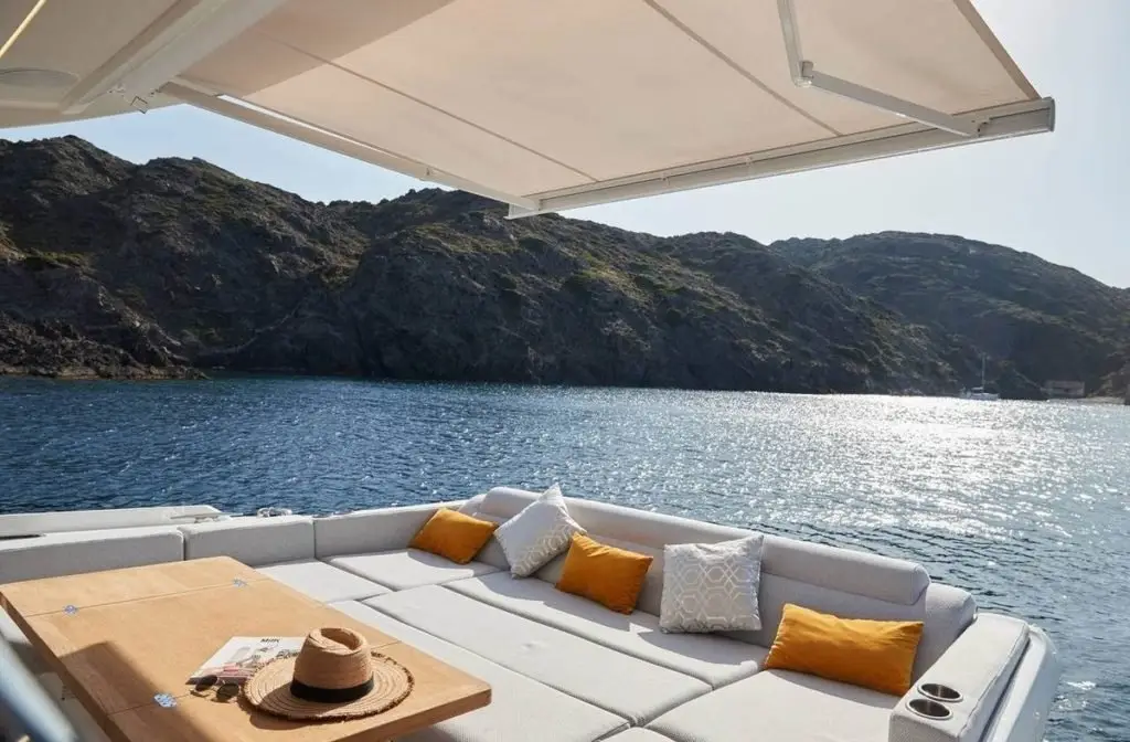Prestige 590 Fly, exterior — Barcelona Yacht Rental, Barcelona. Sitges coves by day, flybridge sunsets by dusk